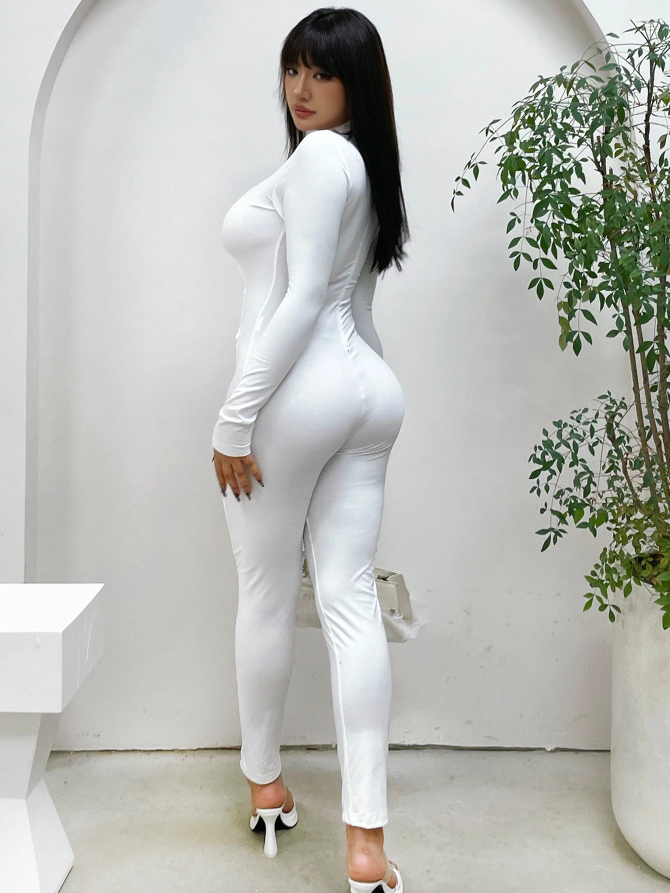 Women's stand up collar tight solid color jumpsuit with metal circle decoration long sleeved all-in-one pants, fitness leggings